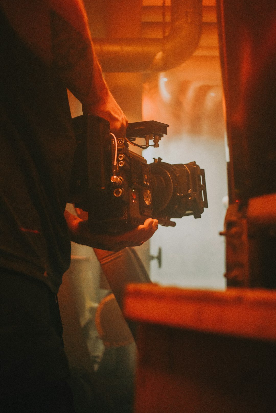 filmmaker adjusting camera settings